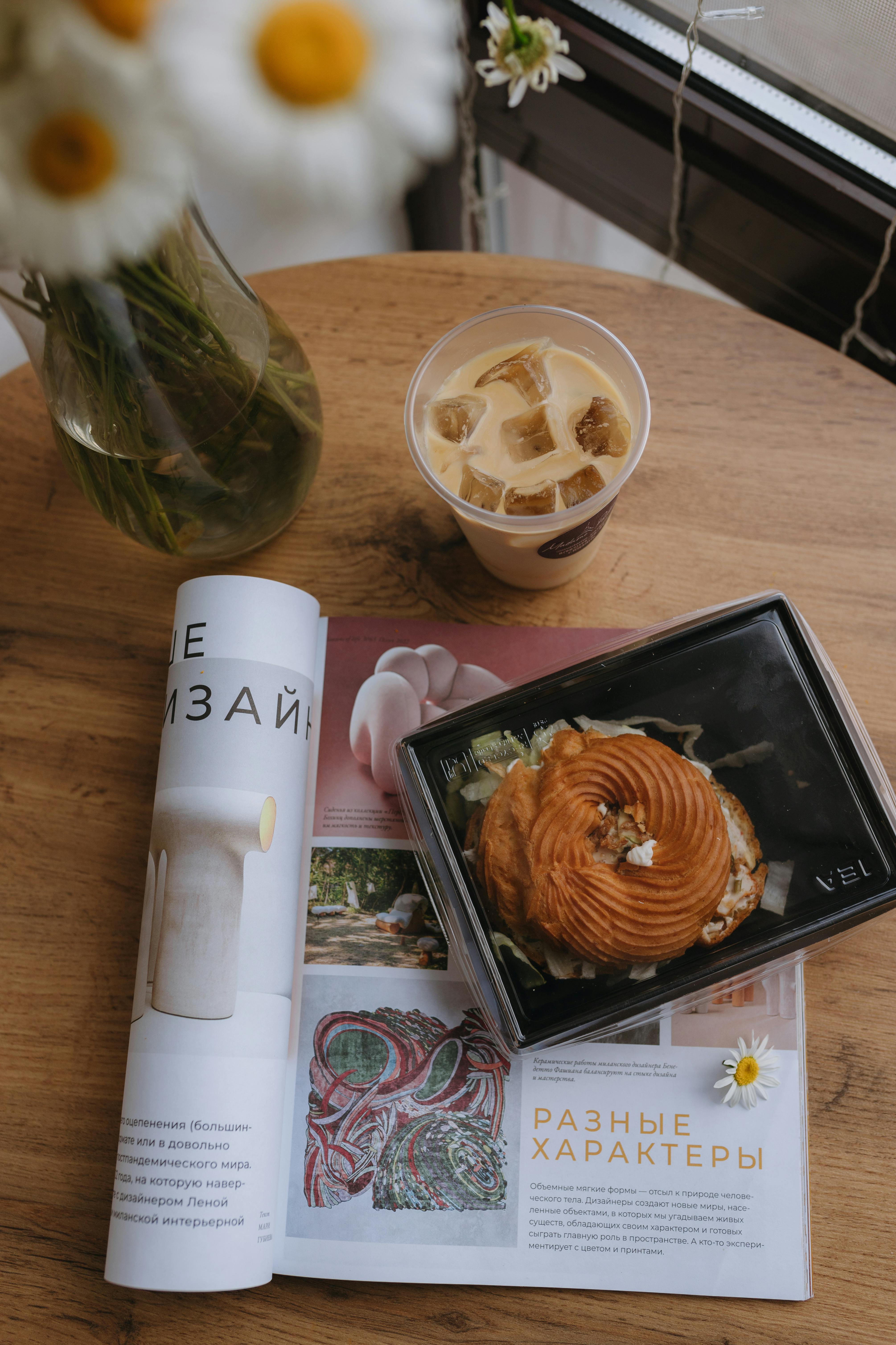 a magazine with a coffee and a donut on a table