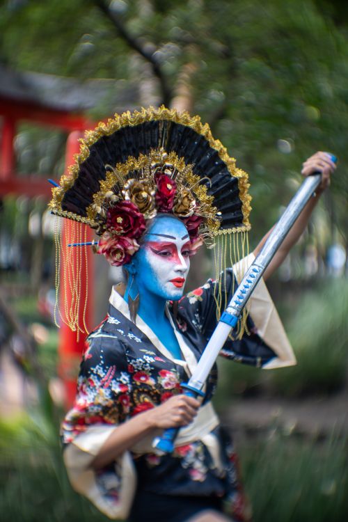 Free A person in colorful traditional attire and makeup holding a sword in a park in Mexico City. Stock Photo