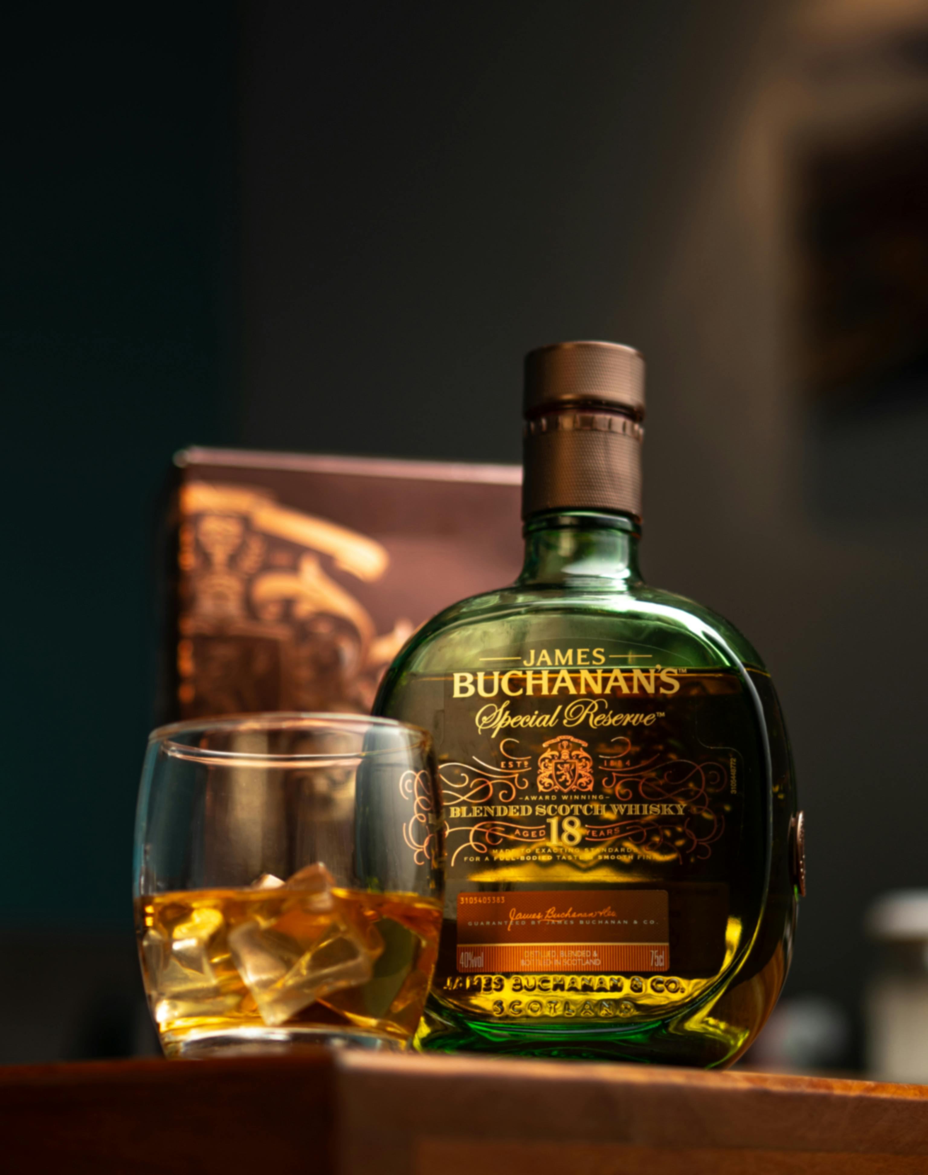 whiskey on wooden table served in a glass