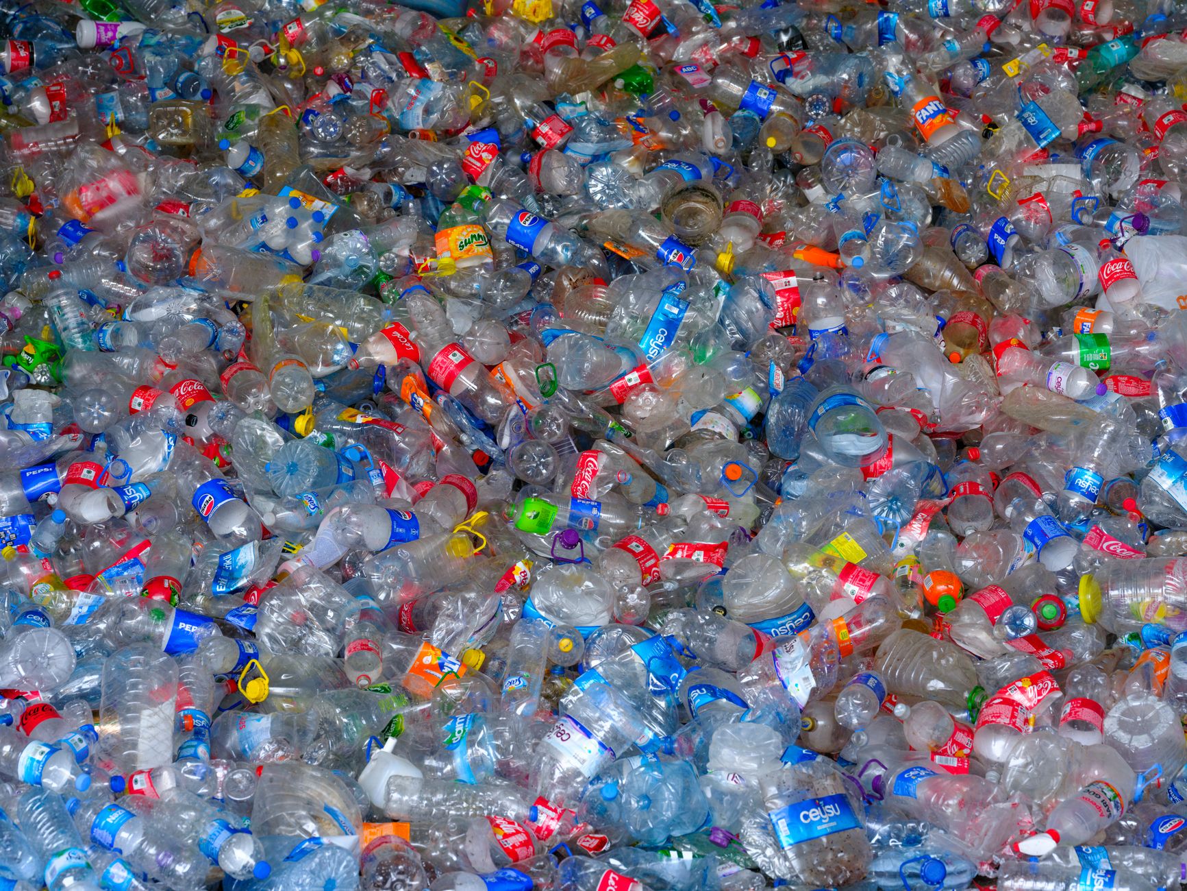 Colorful heap of discarded plastic bottles highlighting recycling and waste management.