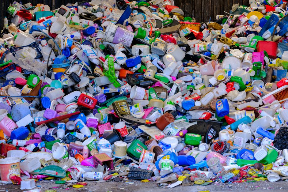 Plastic containers in a landfill highlighting the need for zero-waste cleaning - biodegradable toilet bowl cleaner Plastic containers in a landfill highlighting the need for zero-waste cleaning - biodegradable toilet bowl cleaner