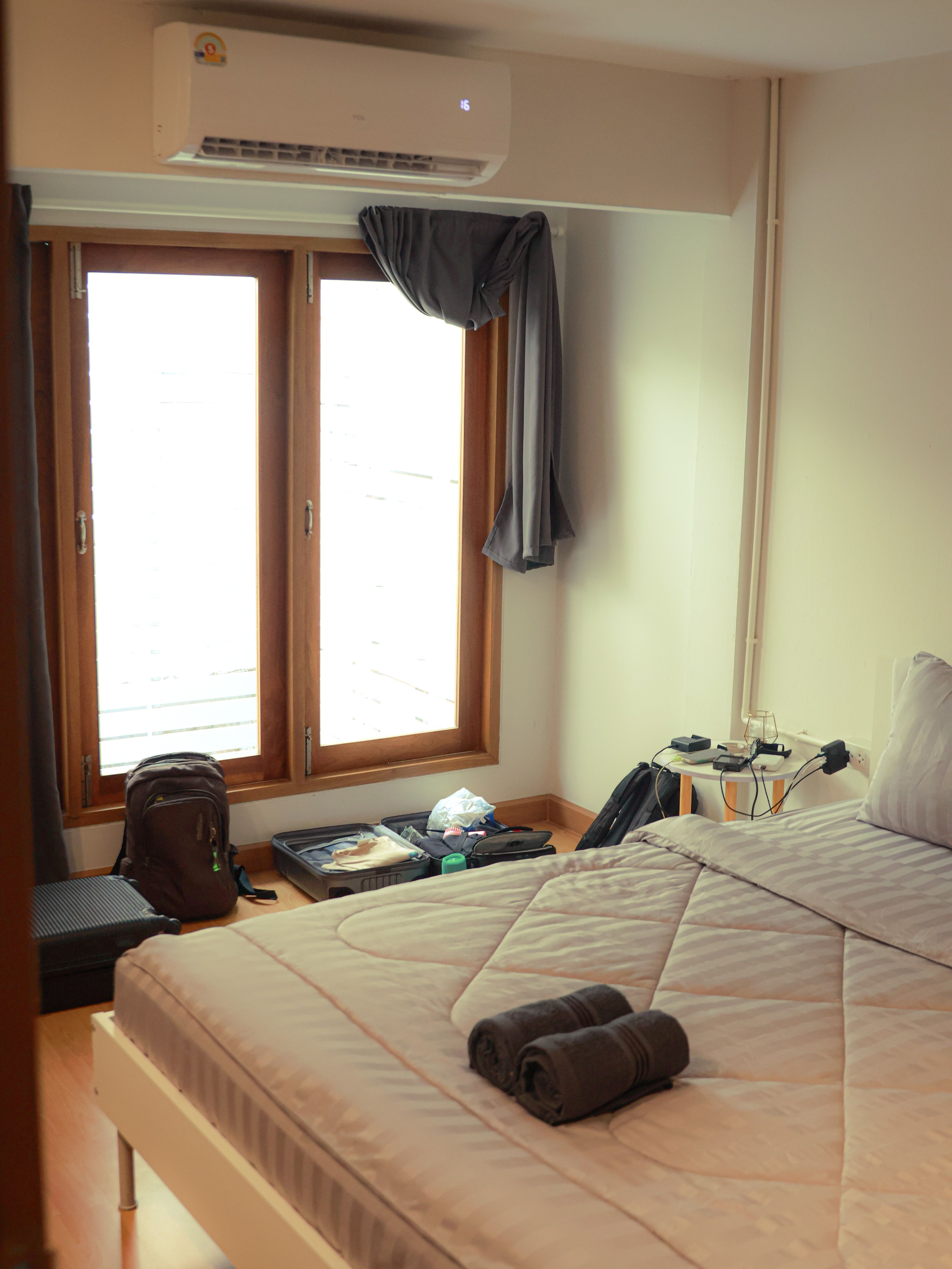 A cozy and modern bedroom interior in Bangkok with natural light and minimalistic decor.
