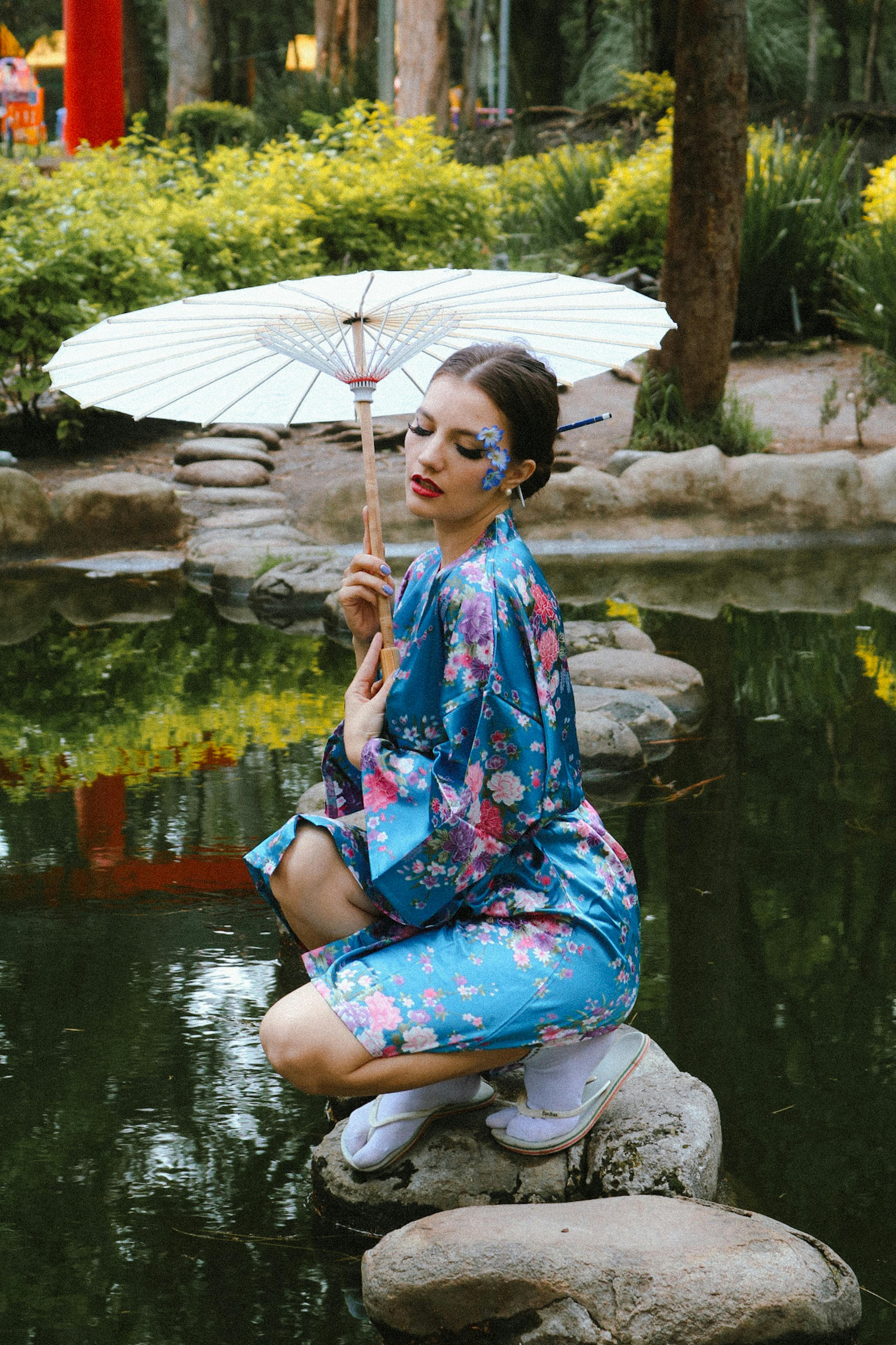 a woman in a kimono holding an umbrella