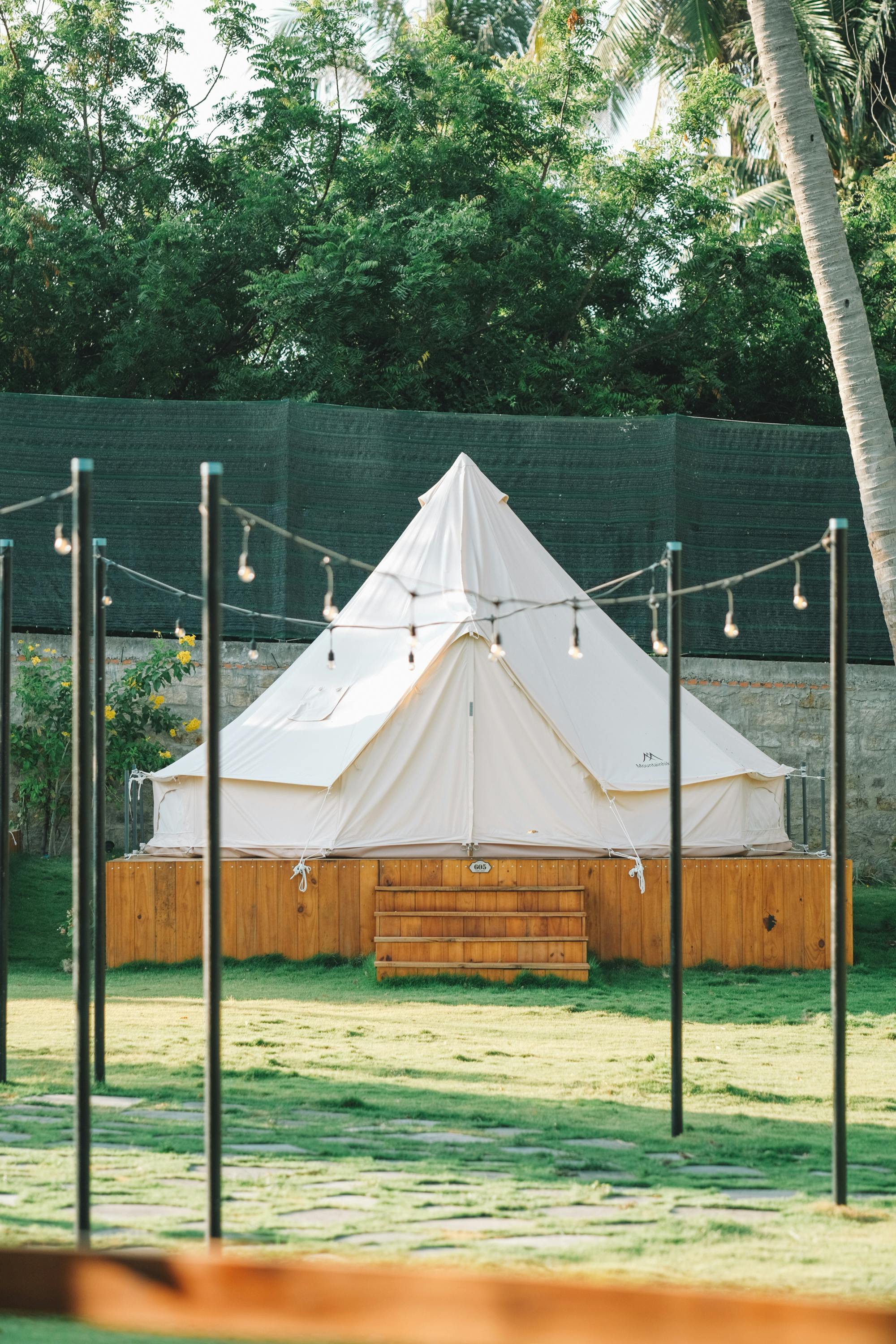 A serene glamping tent surrounded by lush greenery in Phan Thiet, Vietnam.