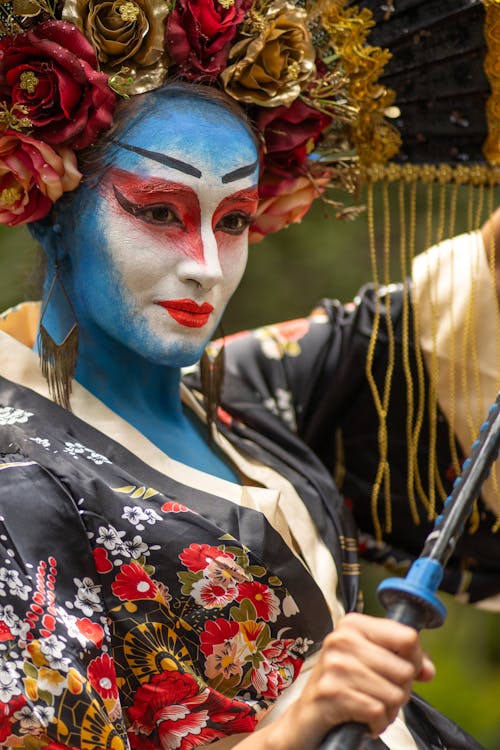 Free A woman with blue face paint and a fan Stock Photo