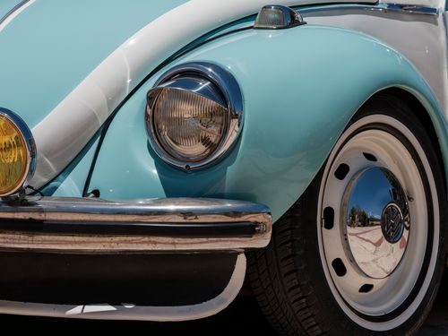 Free A detailed view of a blue vintage Beetle car, showcasing its iconic headlight and chrome features. Stock Photo