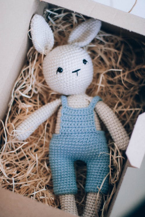 Crochet toy in shape of hare in cardboard box
