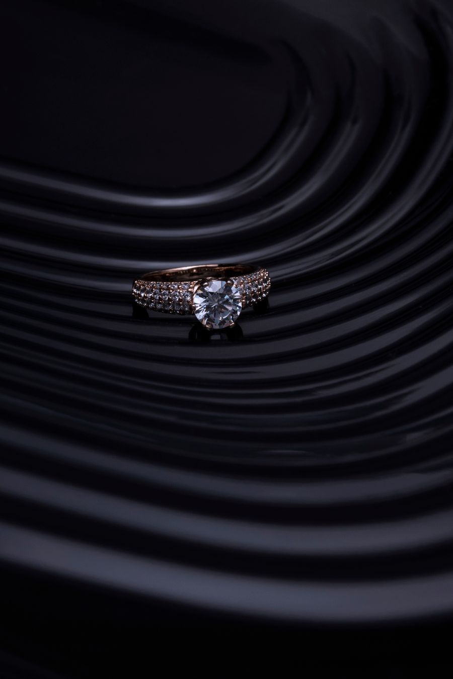 Diamond ring with a dark wavy background