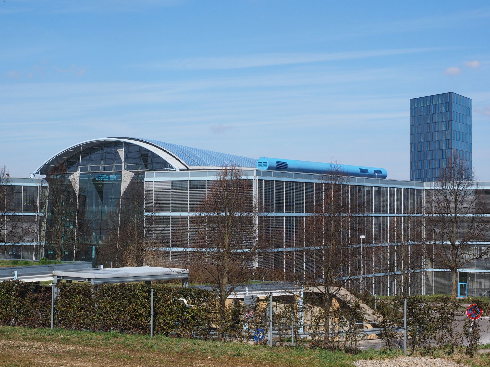 Gray and Blue Glass Building Surrounded by Bare Trees