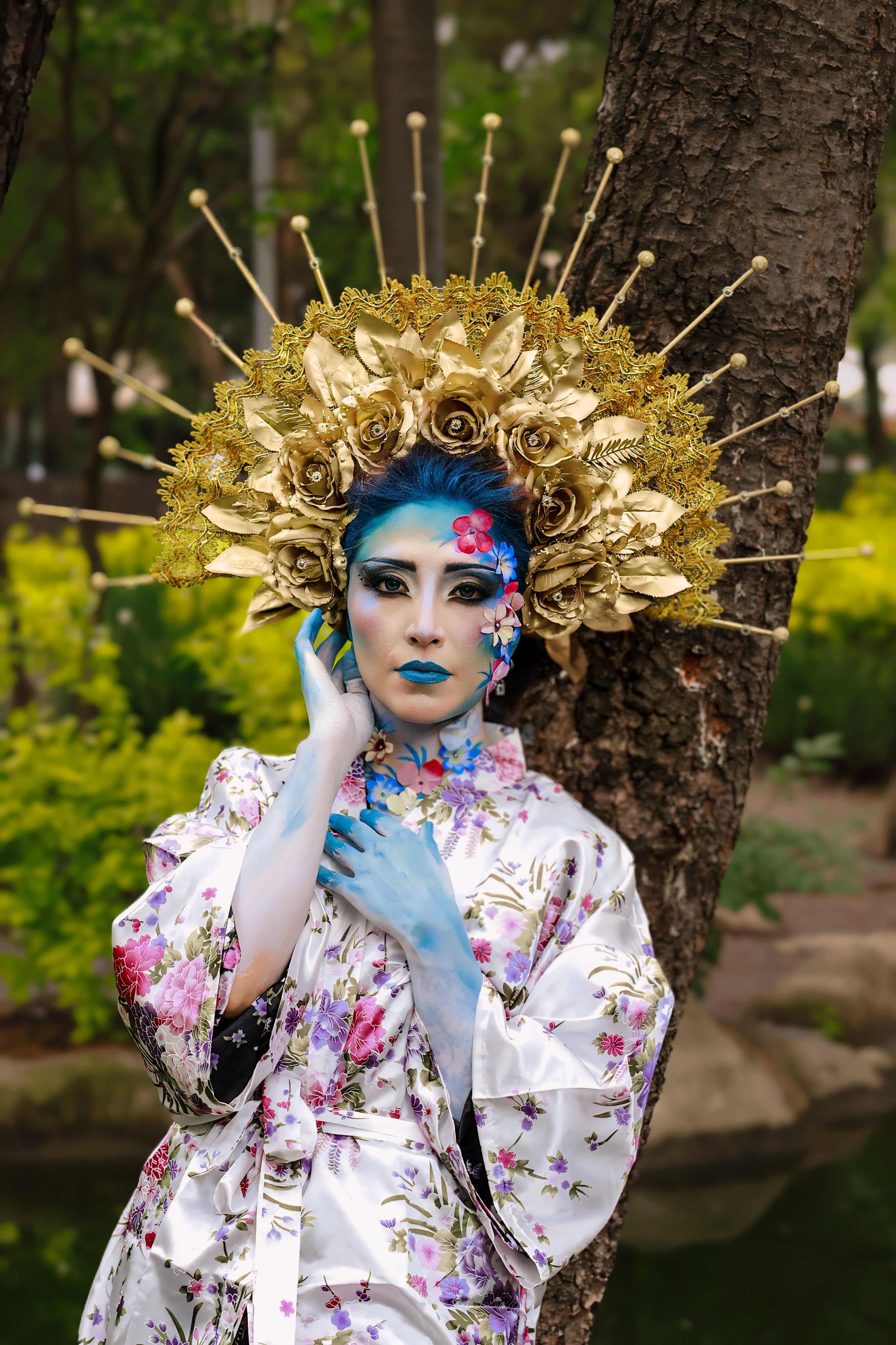 A woman with blue face paint and gold headdress · Free Stock Photo