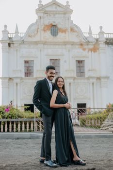 Romantic couple posing at a historical church in Surat, India, embracing love and elegance. - Fotografer Sidoarjo