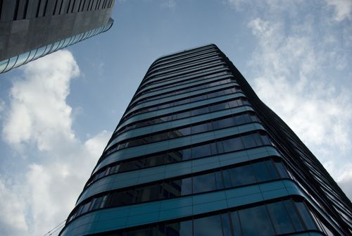Free Low angle view of modern skyscrapers with reflections against a blue sky. Stock Photo