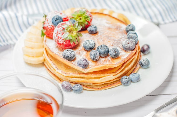 Pancakes With Berries On White Plate