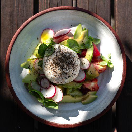 Speckled glazed plate set on a dark table — Thomas Svensson on Pexels
