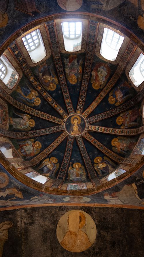 Free A stunning Byzantine dome featuring detailed religious frescoes and ornate designs illuminated by natural light. Stock Photo
