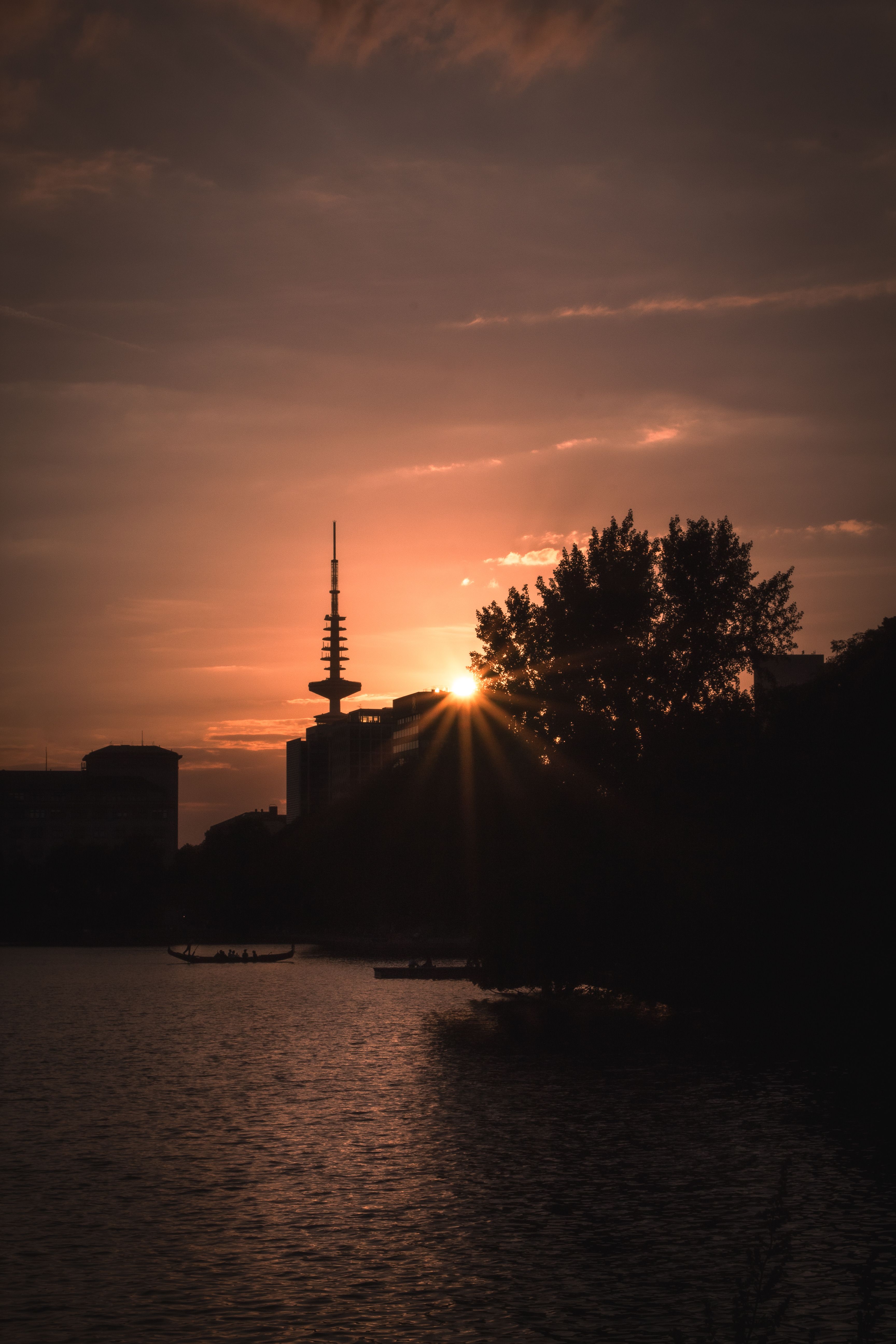Sunset over the city skyline with a tower in the background · Free ...