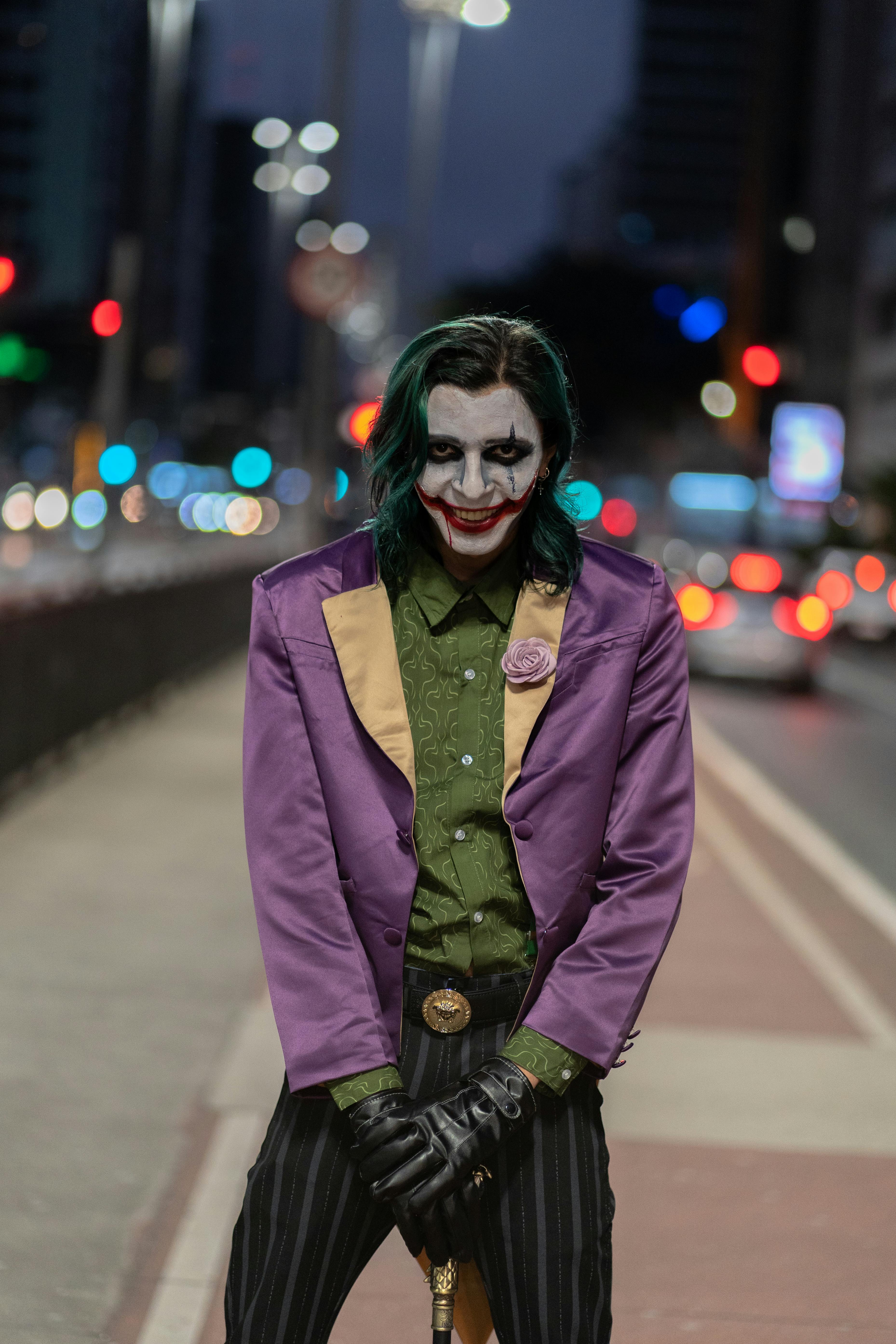 Urban street portrait of a person in a purple costume at night, capturing the essence of city life.
