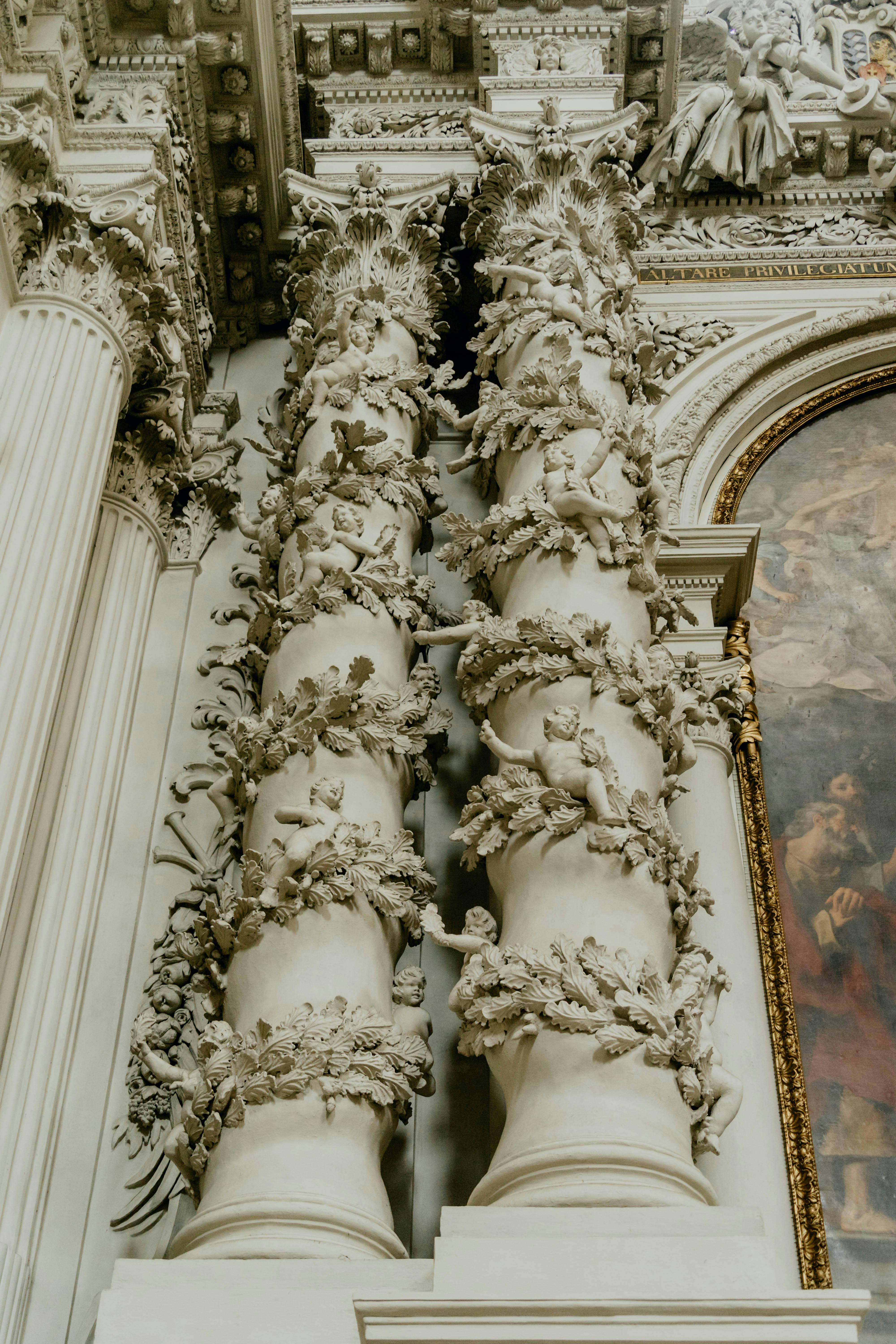 the columns of a church are decorated with angels