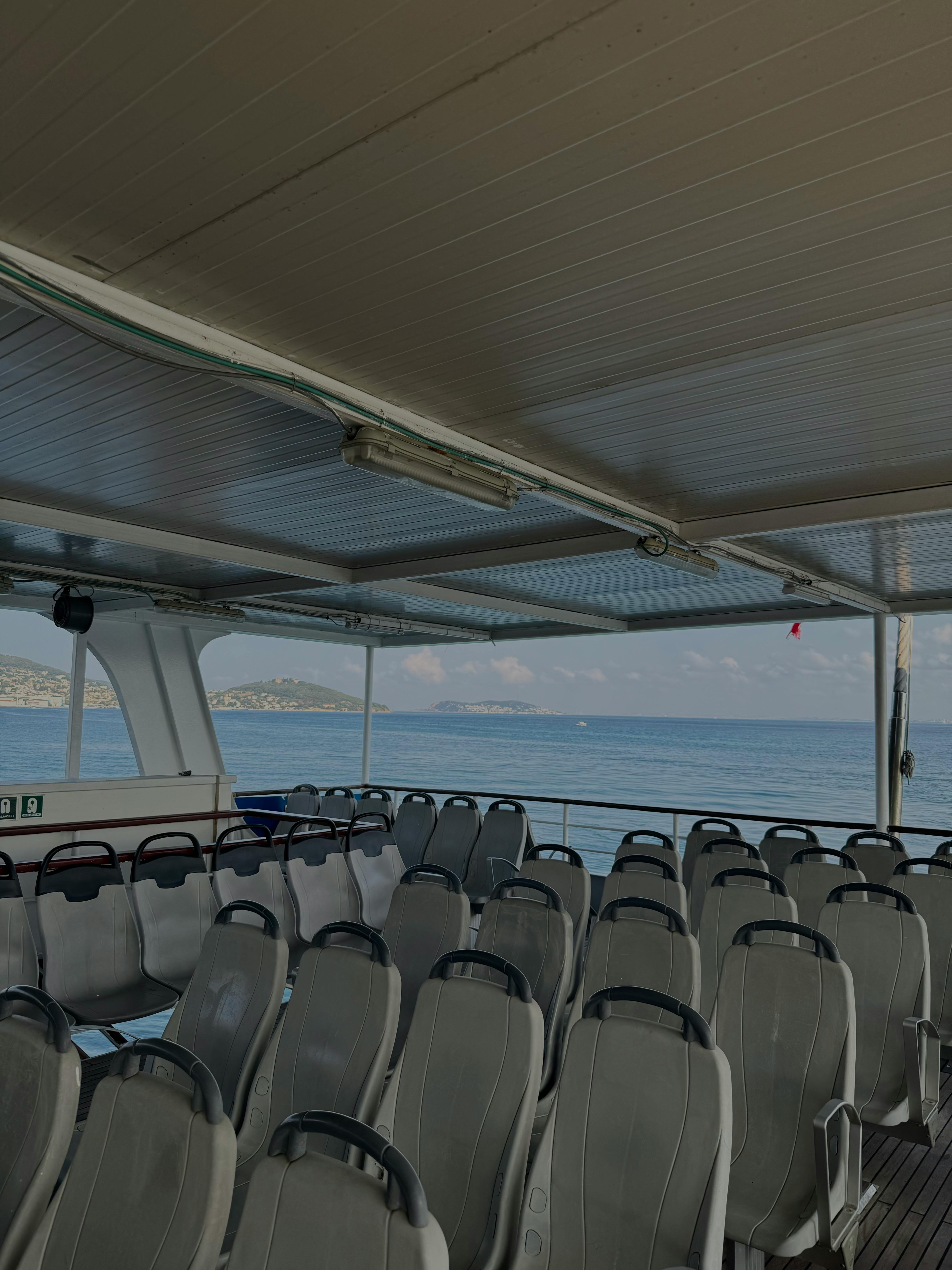 a boat with seats and a view of the ocean