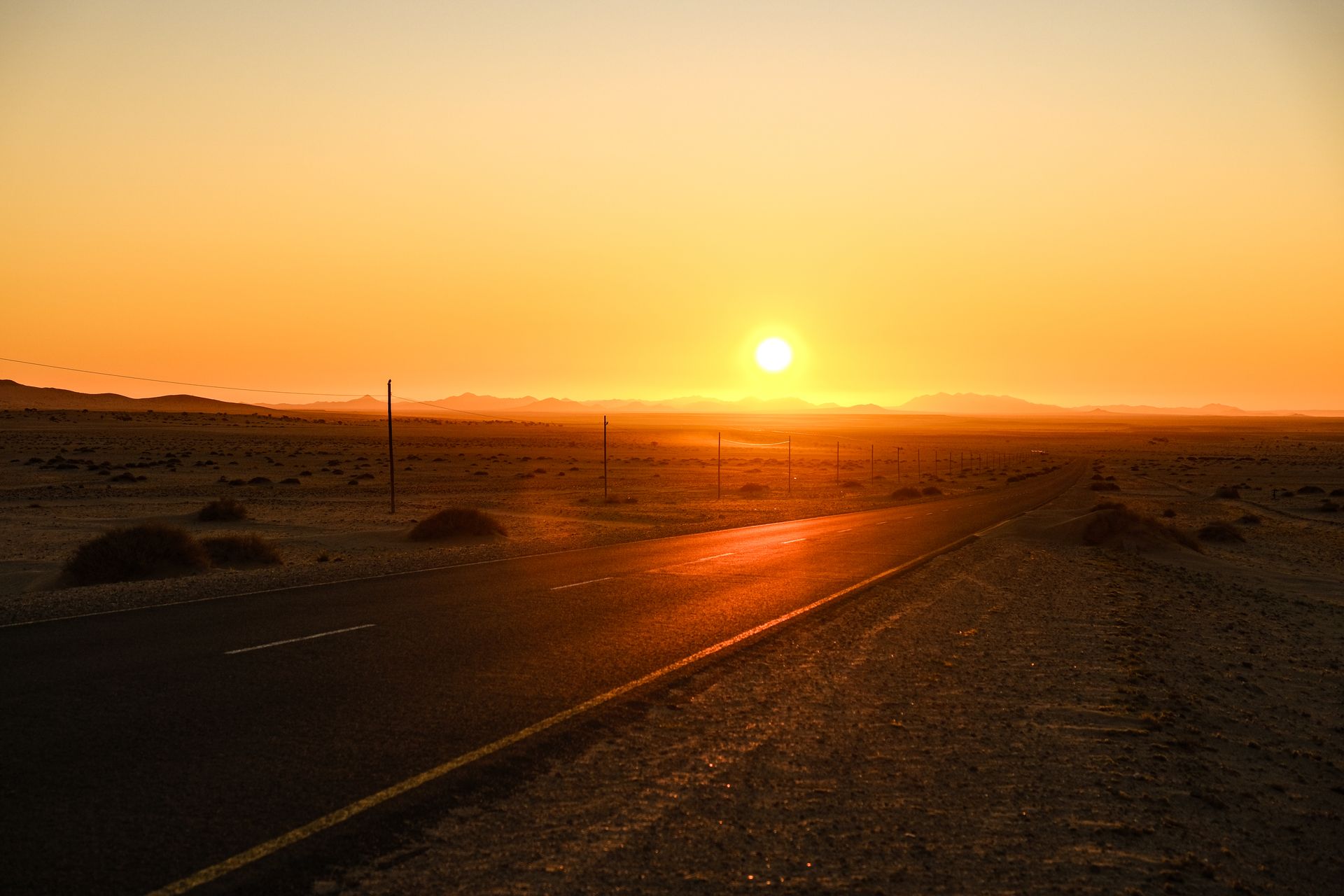 An empty desert road at dusk