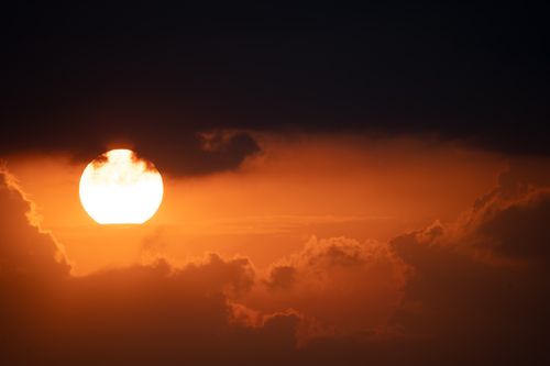 Free Captivating sunset with vibrant orange hues and silhouetted clouds over Nelson, WI. Stock Photo