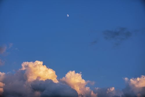 Free Vivid blue sky with moon and sunset-lit clouds in Nelson, Wisconsin. Stock Photo