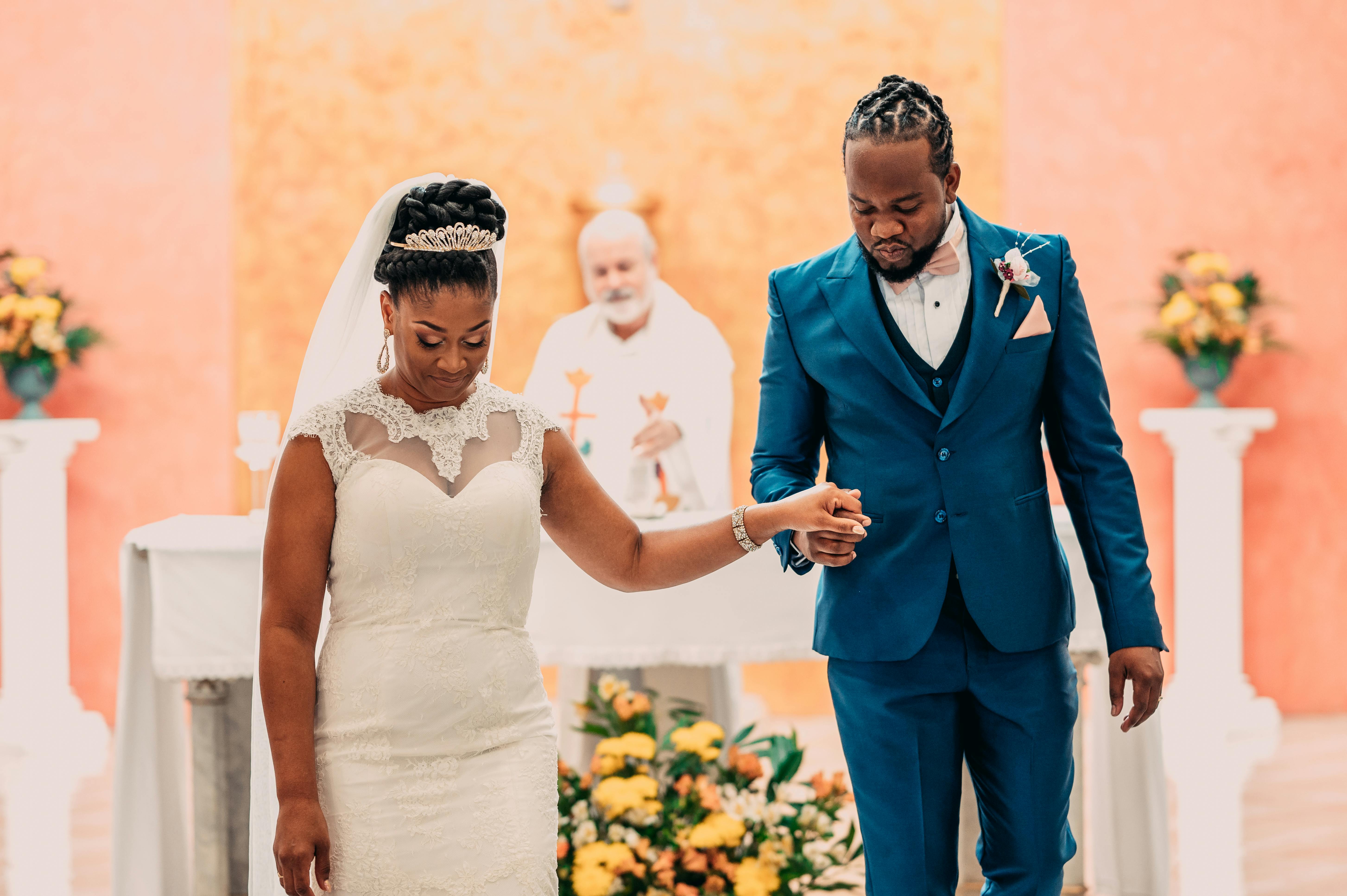 a bride and groom walking down the aisle