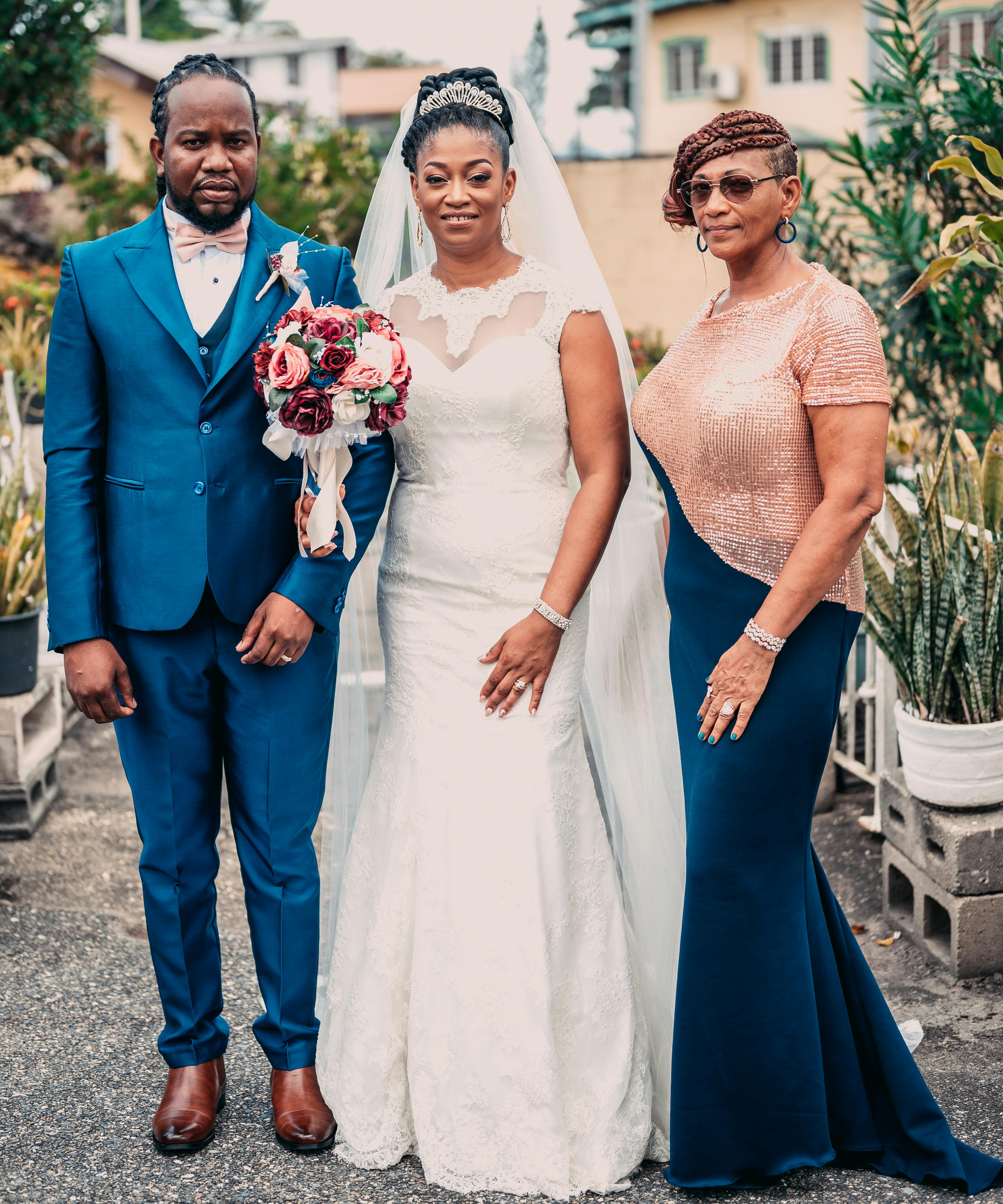 A stylish wedding portrait of a couple with a guest in Port of Spain, Trinidad and Tobago.