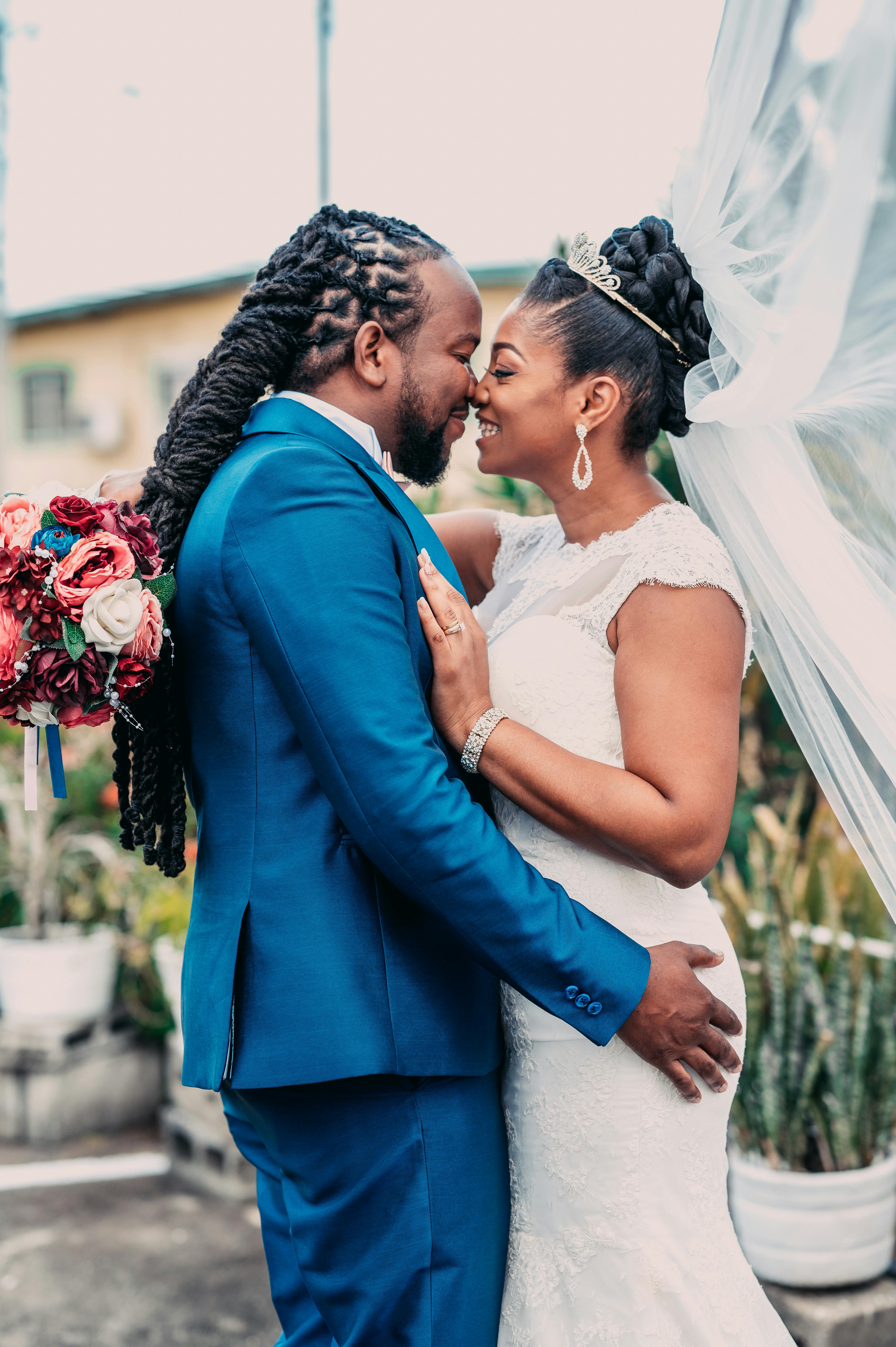 A joyful bride and groom sharing a loving embrace outdoors in Port of Spain, Trinidad.