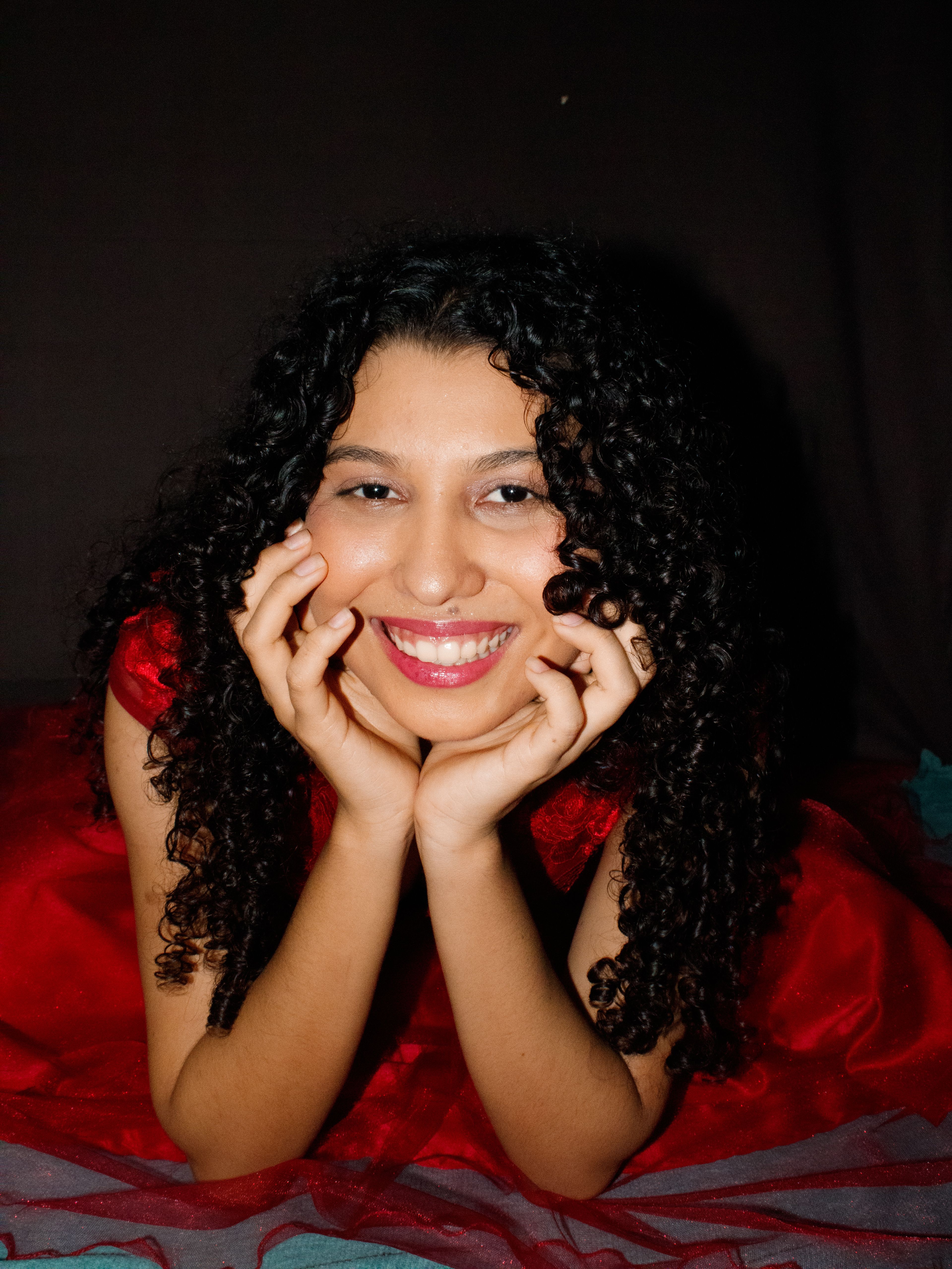 Smiling Woman with Curly Hair · Free Stock Photo