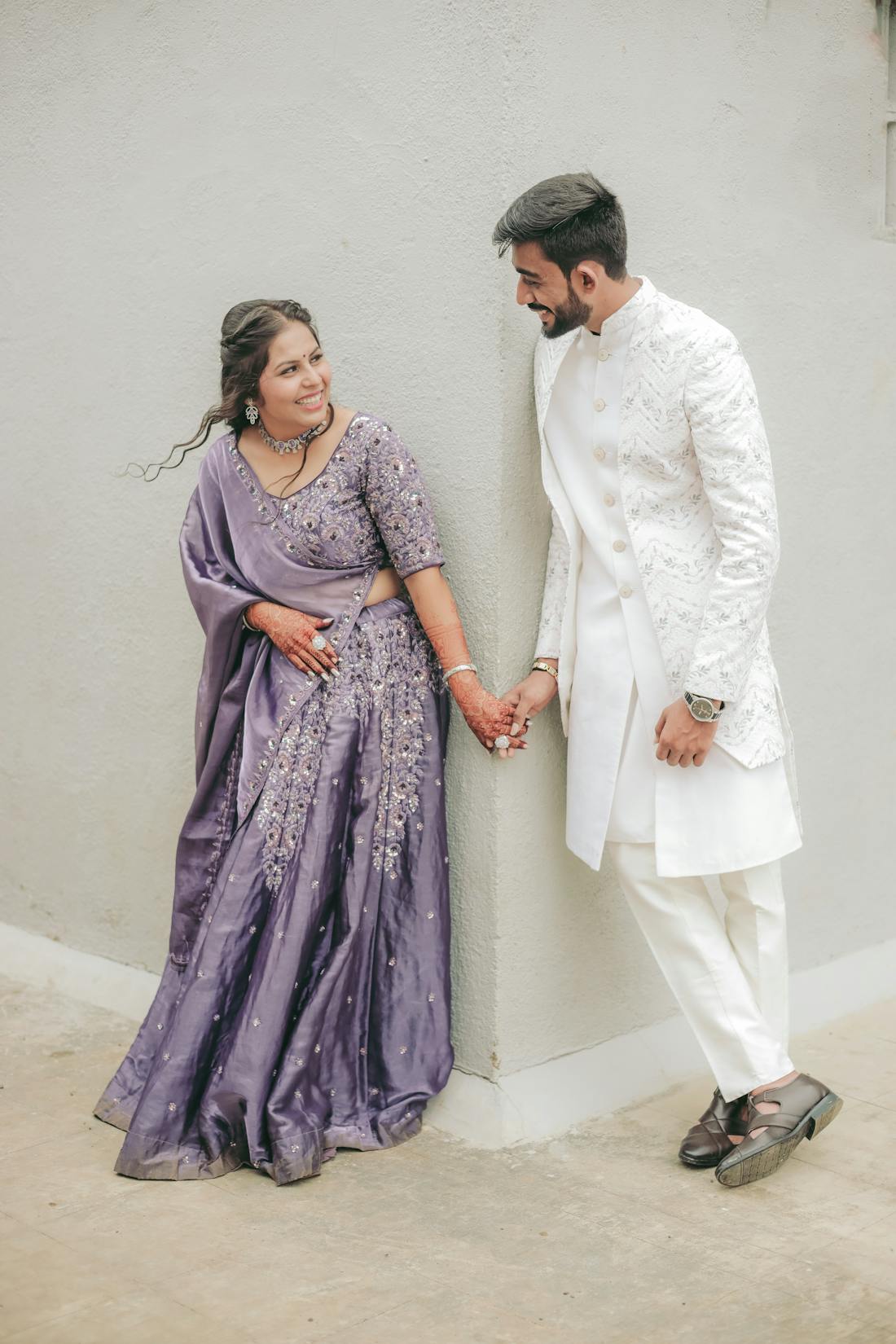 Couple in coordinated lehenga and blouse set during an outdoor celebration