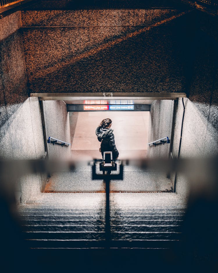 Photo Of A Woman Walking On Stairs