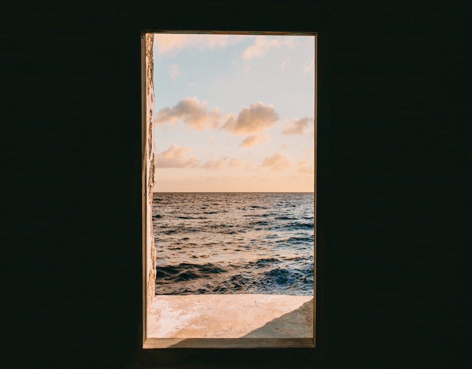 Free Window View of Sea during Golden Hour Stock Photo