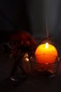 Close-Up Photo of Lighted Incense Stick Near Candle