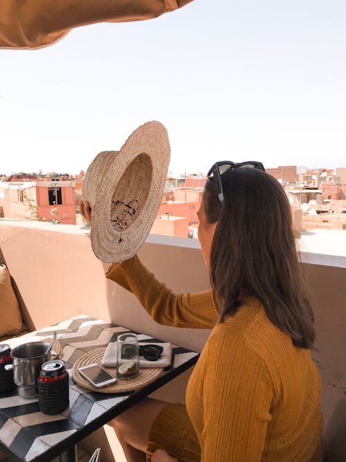 Woman Holding Strawhat