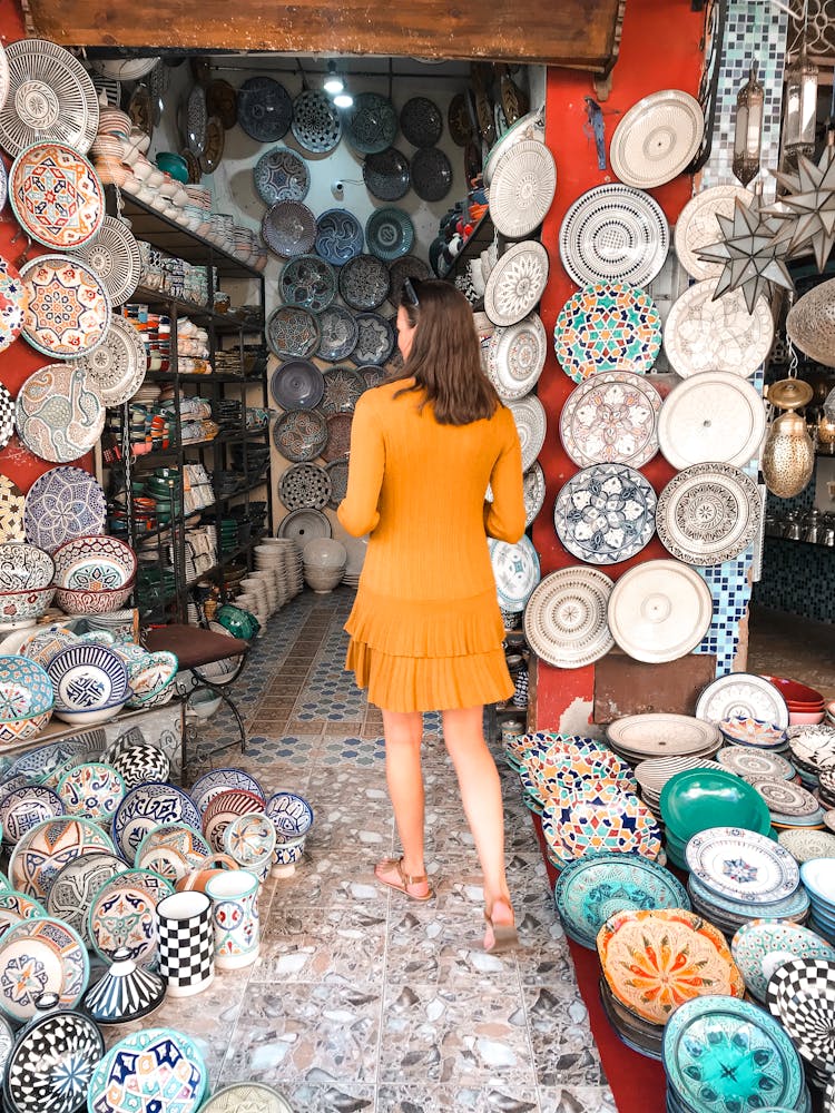 Woman In Ceramic Plates Shop