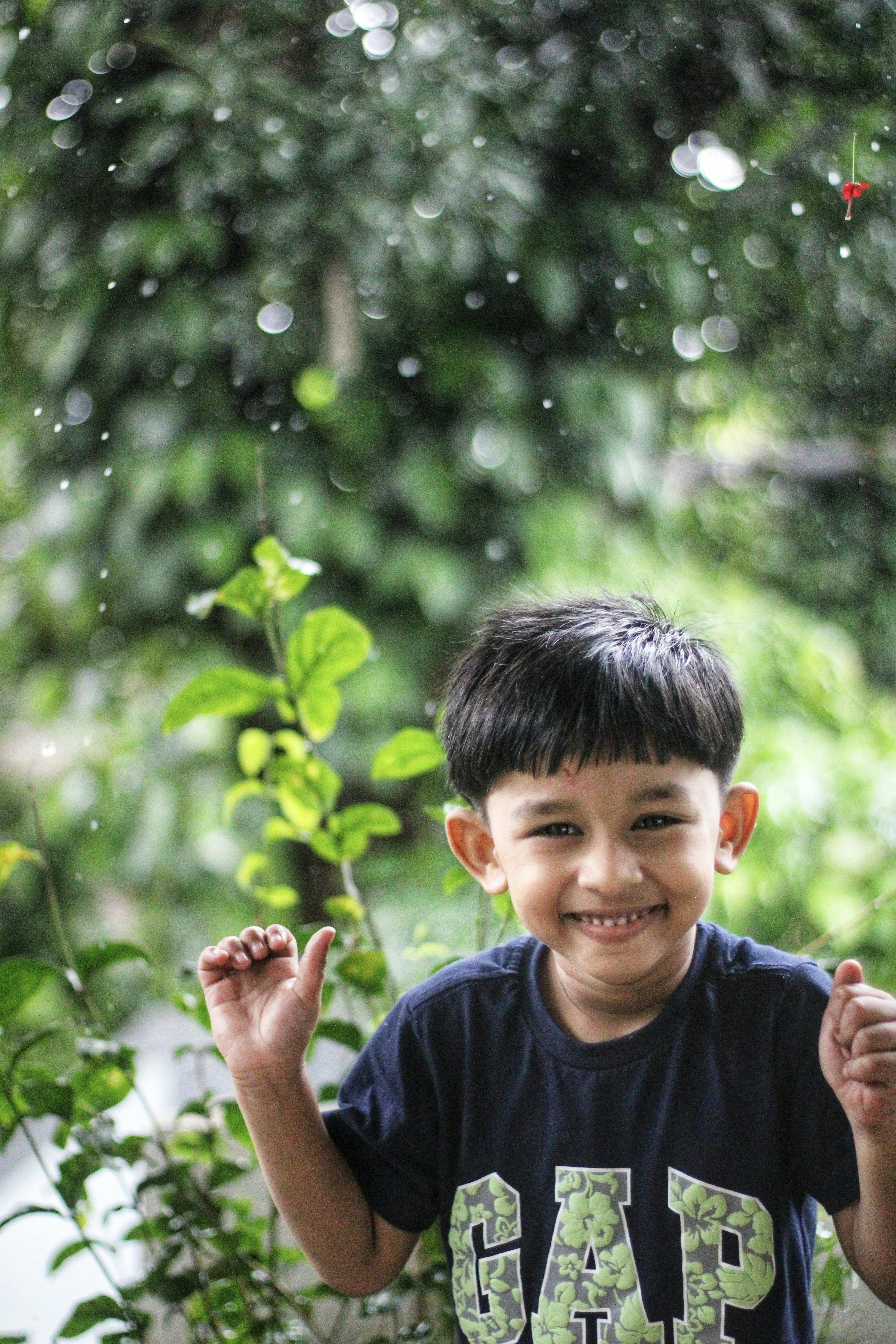 happy kid enjoying the rain happy boy enjoying the rain