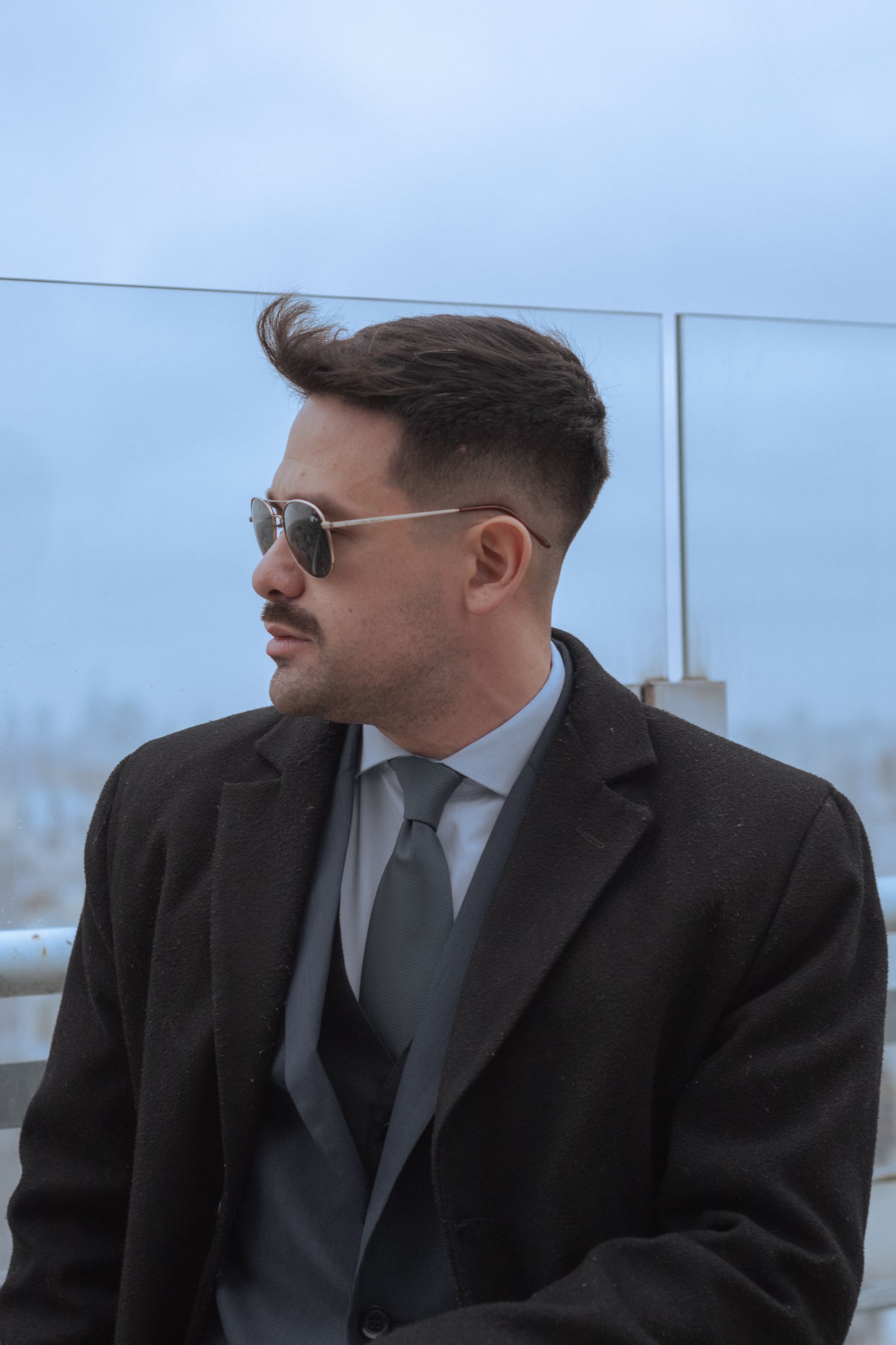 A man in a suit and tie is looking out over the city · Free Stock Photo