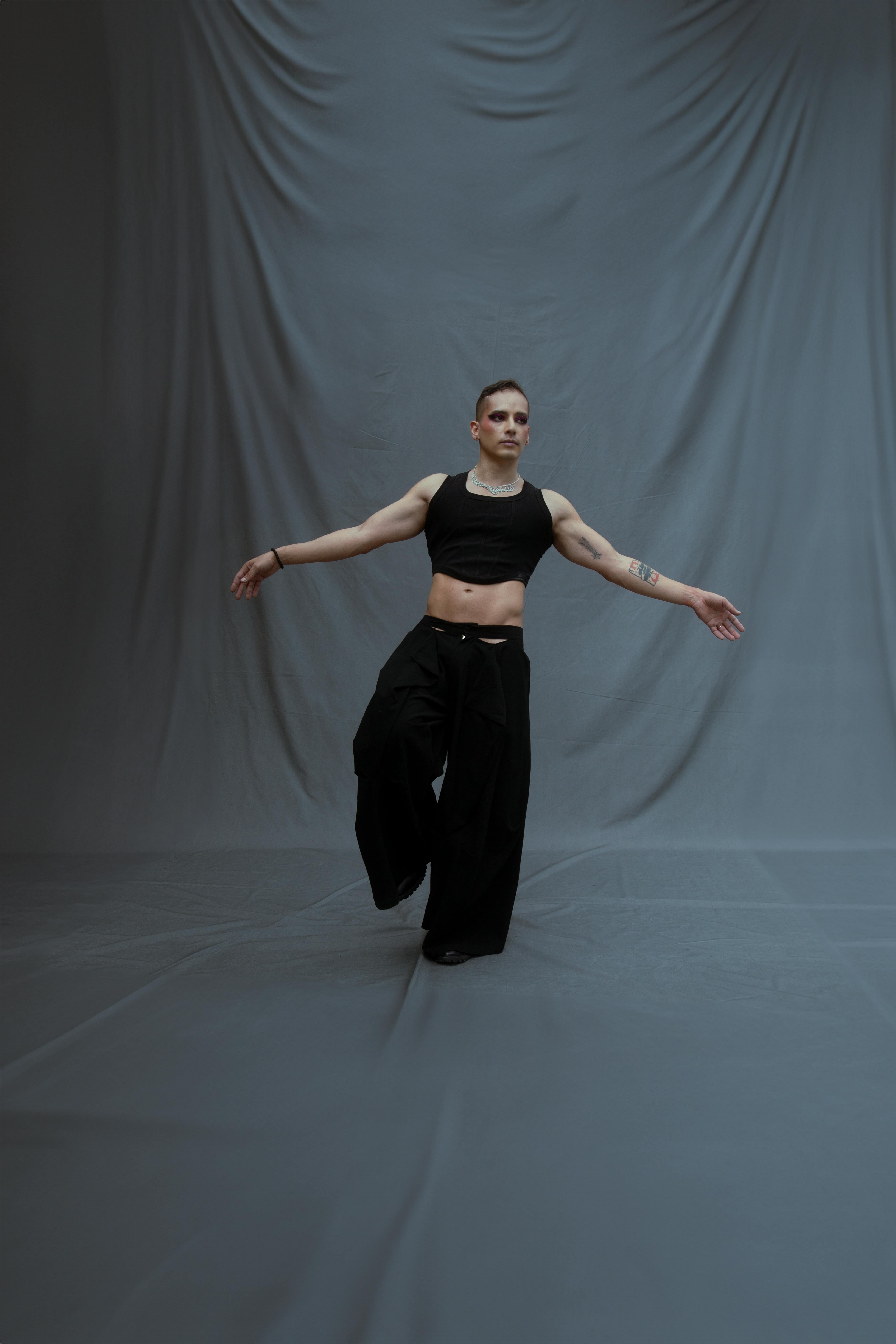 Free A stylish young dancer displays grace and agility in a studio, showcasing modern fashion and movement. Stock Photo