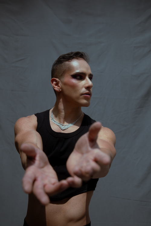 Free A striking portrait of a man in expressive pose and modern fashion. Stock Photo