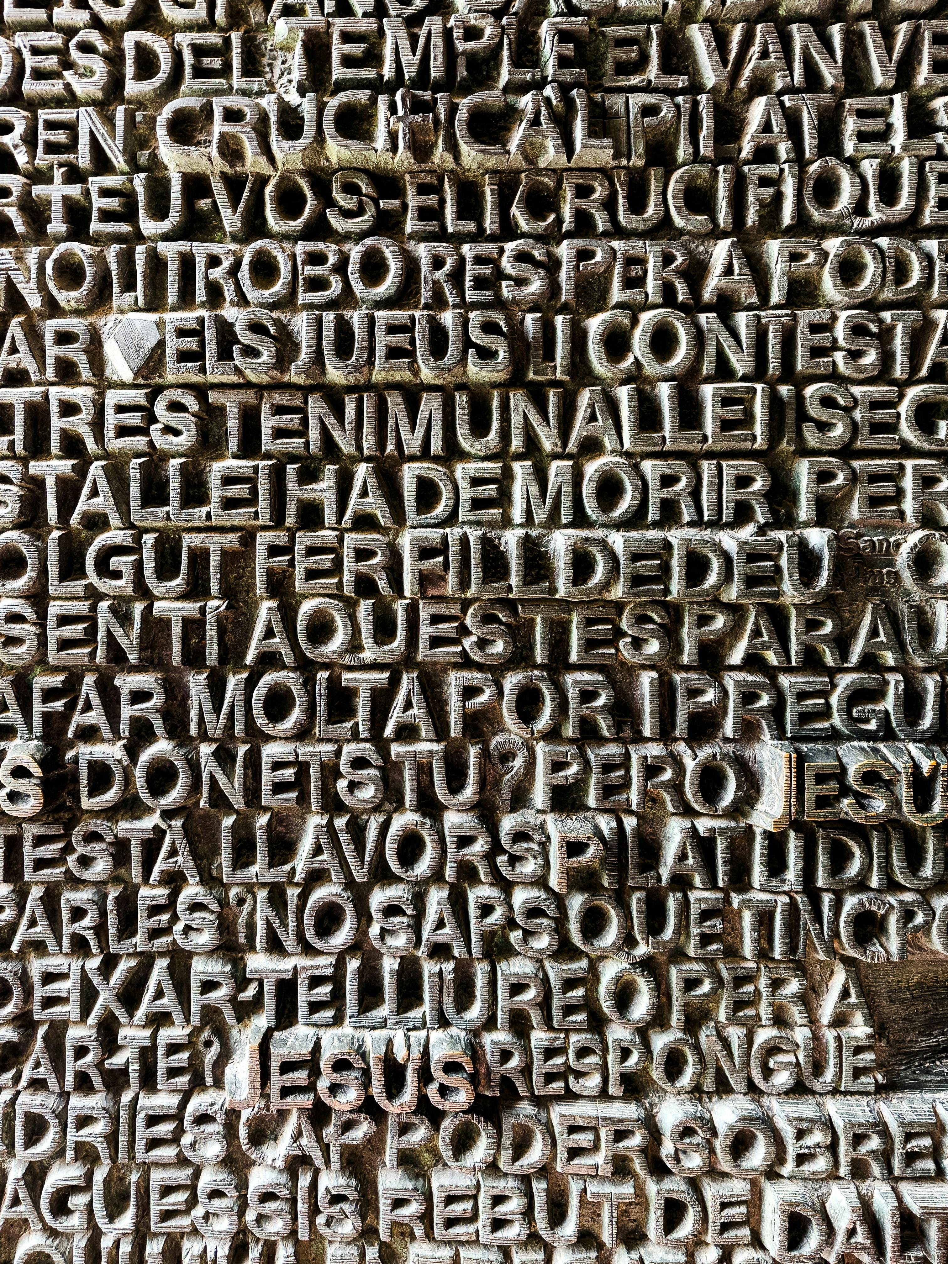 a close up of a wooden plaque with many different languages