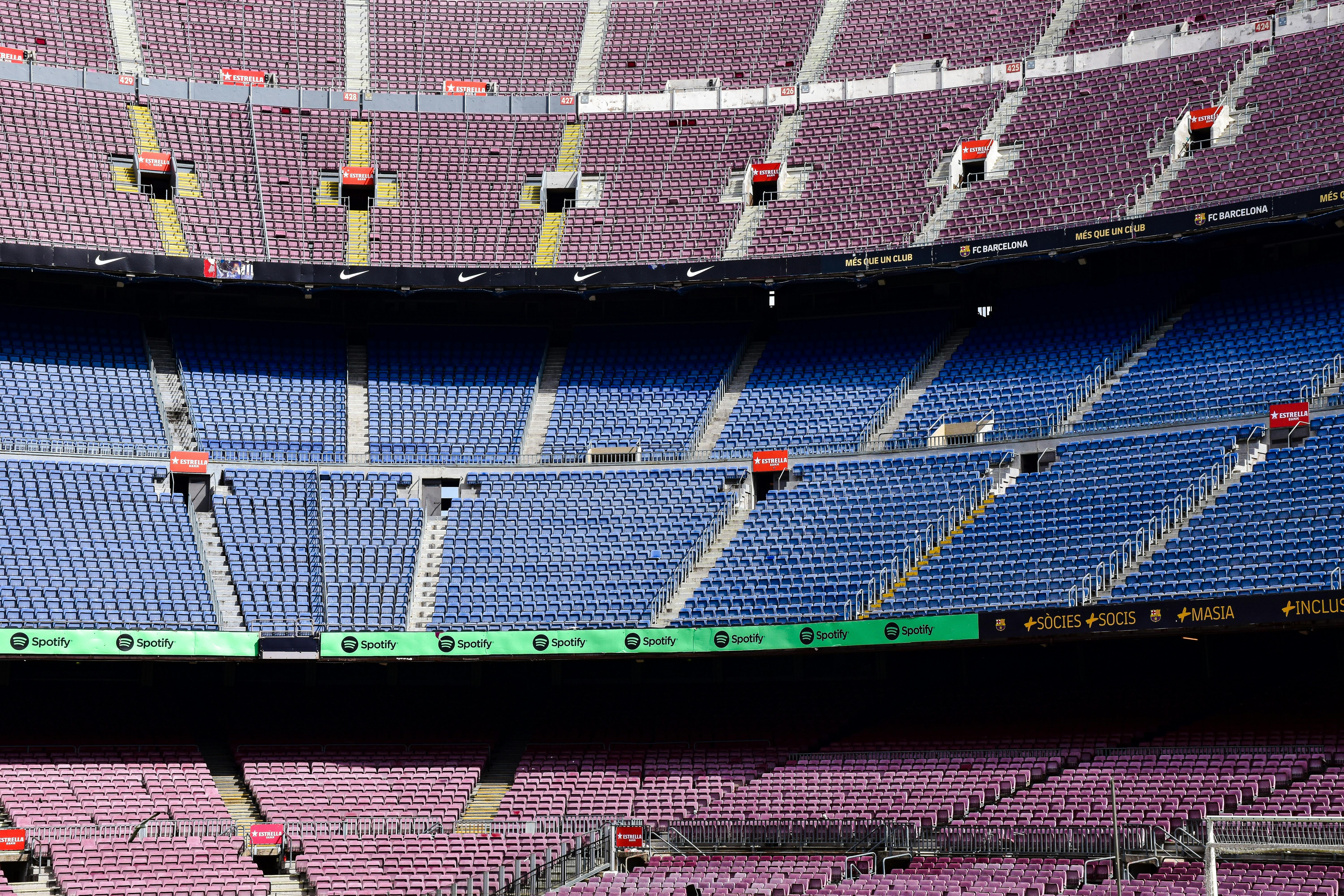 a soccer stadium with blue seats and a soccer ball