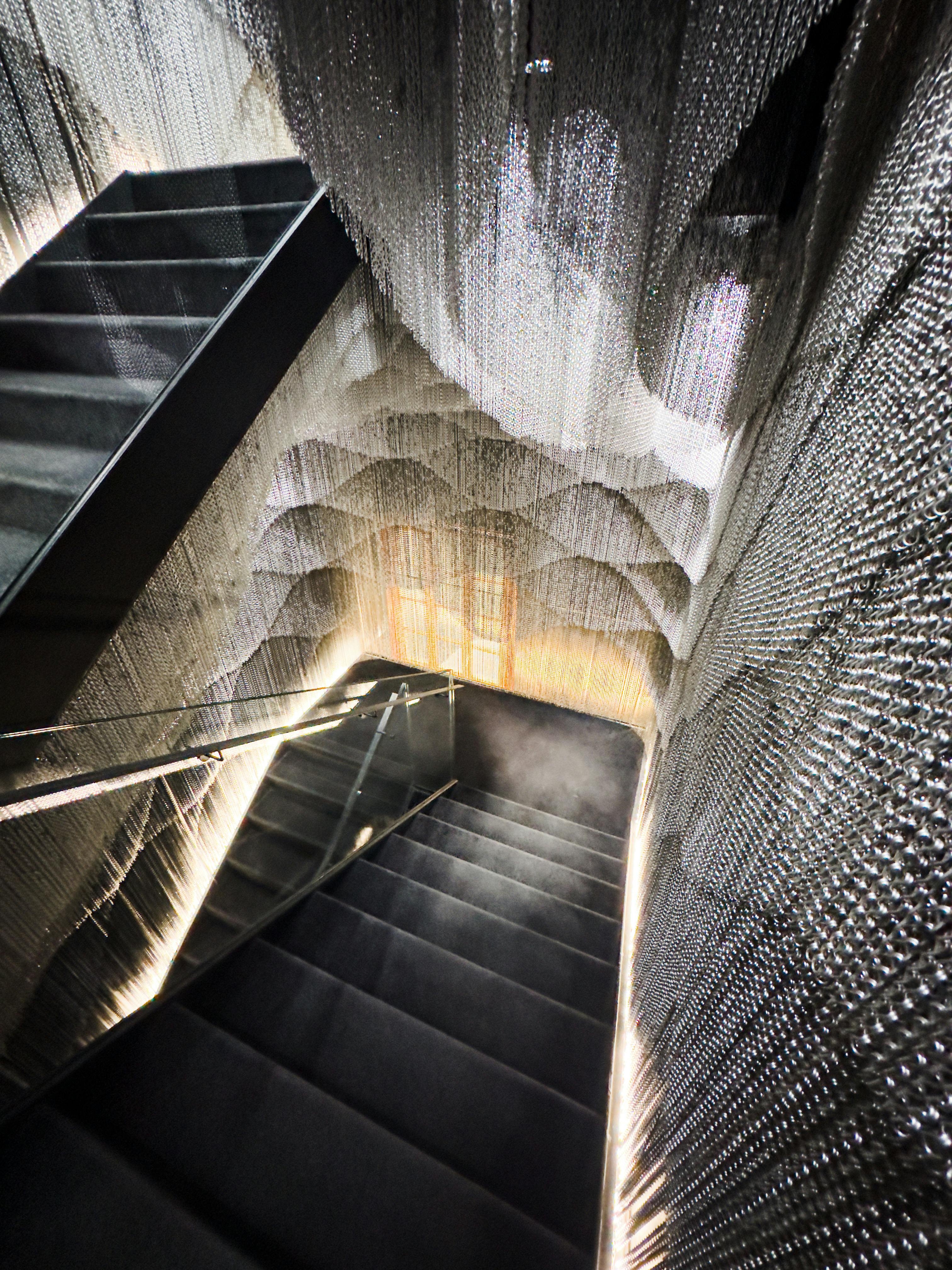 a staircase with a long white woven carpet