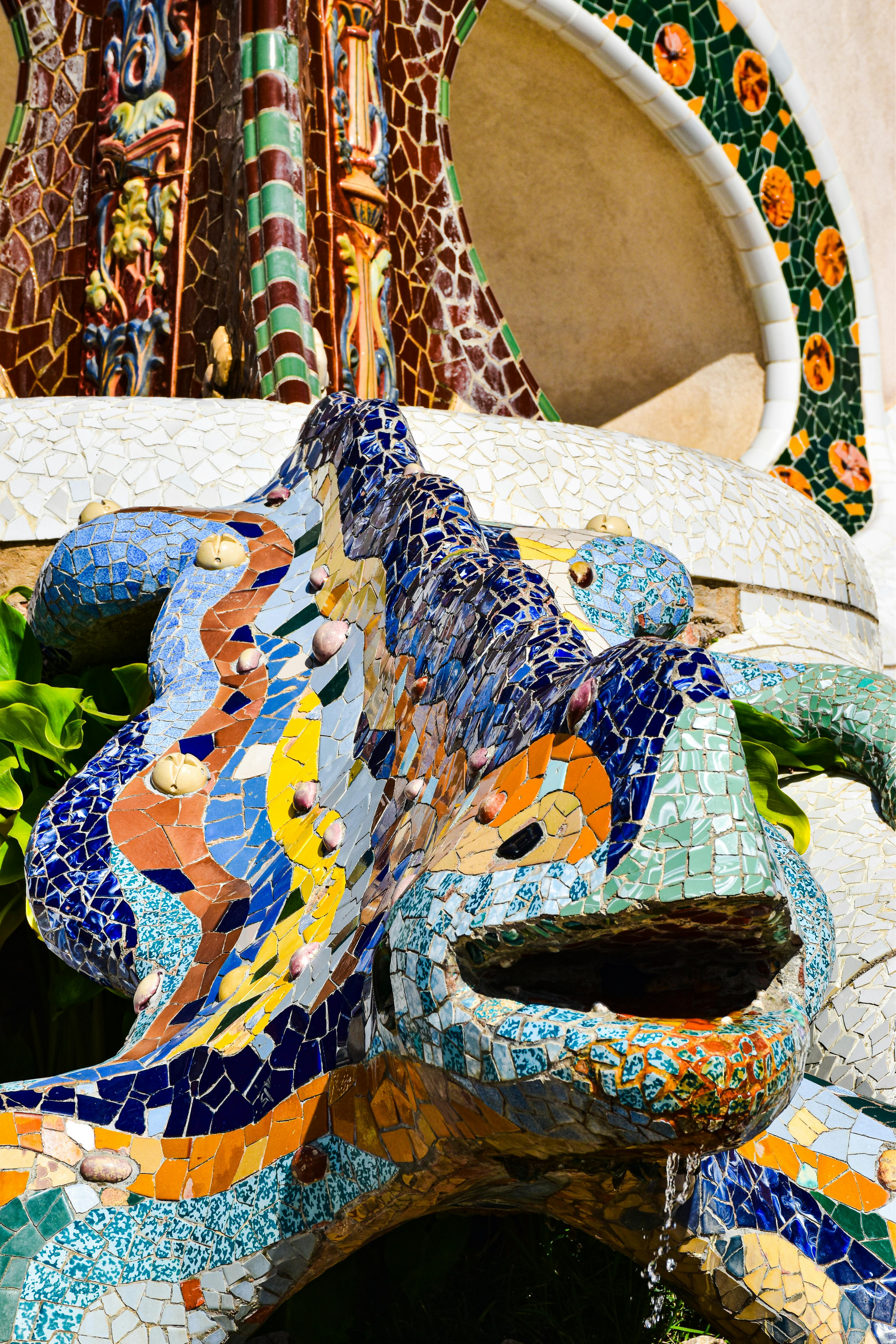 a colorful statue of a dragon with a colorful mosaic