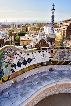 Vibrant mosaic bench at Park Güell showcasing Barcelona's cityscape.