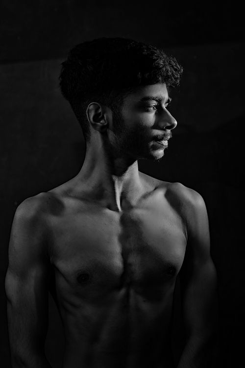 Free Artistic black and white portrait of a shirtless man highlighting strength and contemplation. Stock Photo