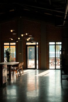Spacious interior with stylish furniture and abundant natural light through large windows. - Fotografer Sidoarjo