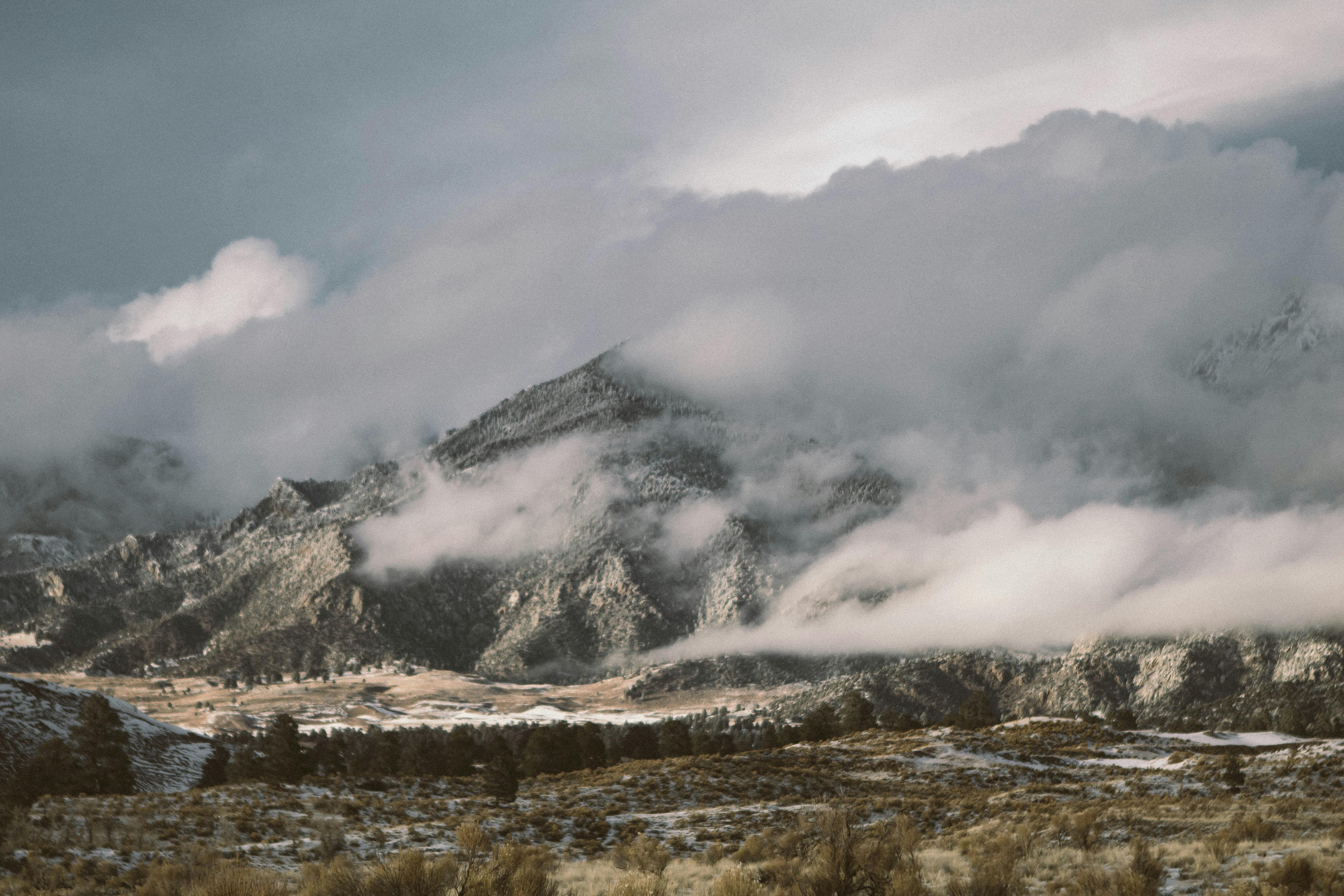 a cloudy sky over mountains and snow