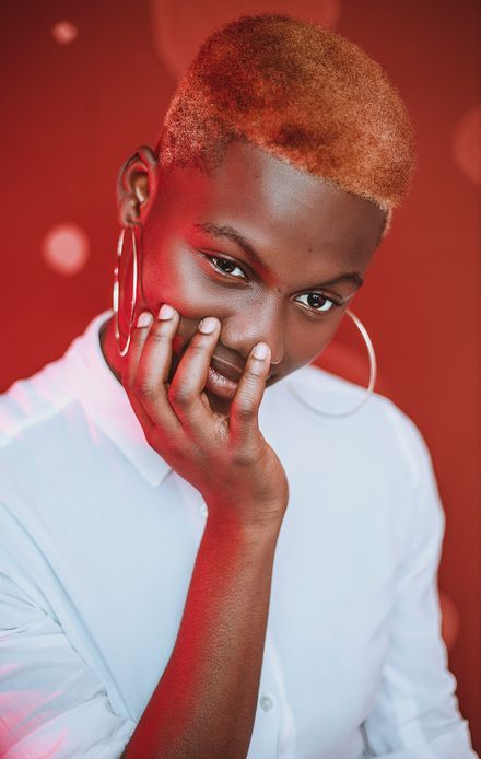 Portrait in a white shirt against a red backdrop — Jeffrey Paa Kwesi Opare on Pexels