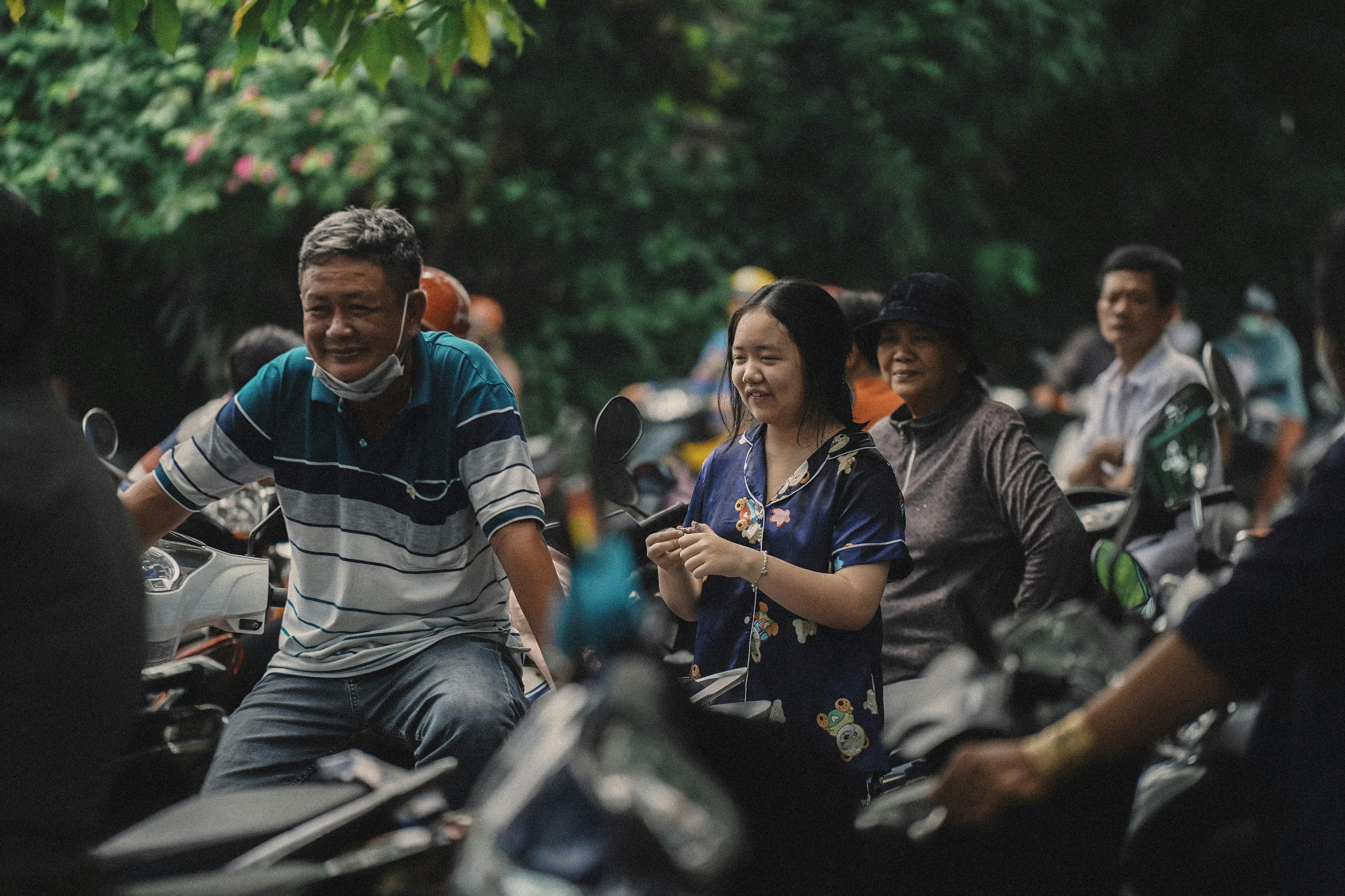 a group of people riding motorcycles in a city